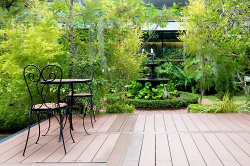 gallery-1491562594-black-chair-in-wood-patio-at-green-garden-with-fountain-in-house-outdoor-garden